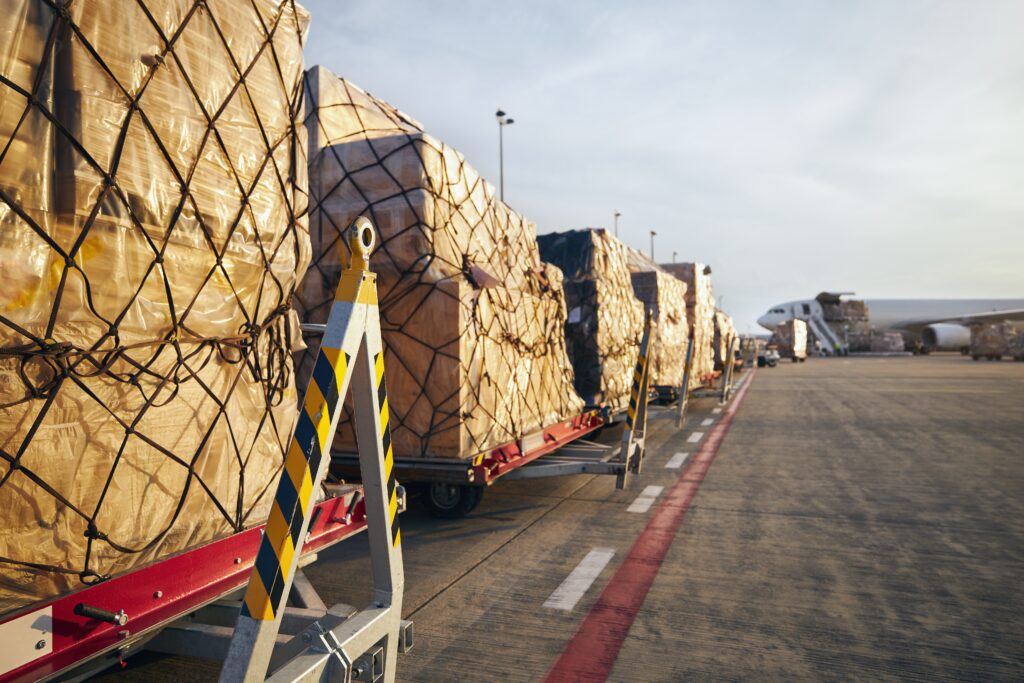 Loading of cargo containers to airplane at airport.